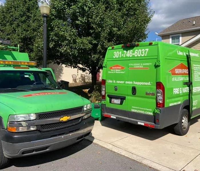 Two vehicles are parked outside of a customer's home 